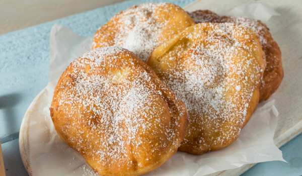 Close-up of soft and golden Deep Fried Elephant Ears Recipe, dusted generously with powdered sugar for a sweet and indulgent treat.