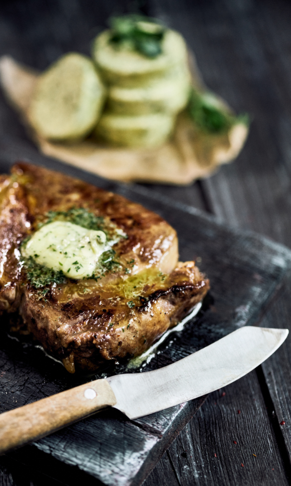 Creamy compound with fresh herbs, ready to complement steaks or grilled dishes.