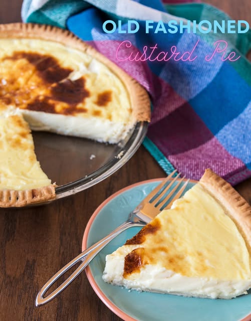 Old Fashioned Custard Pie with a golden-brown crust and creamy custard filling, served on a pastel plate with a fork. A classic dessert perfect for family gatherings or holidays.