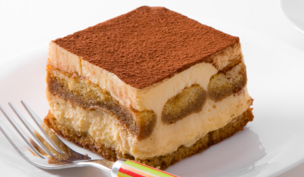 Elegant tiramisu with creamy layers and a light cocoa topping and ladyfingers