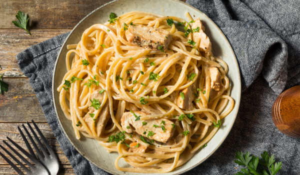 Louisiana-style chicken pasta on a rustic plate, featuring a creamy Cajun sauce, tender chicken, and perfectly cooked linguine, garnished with fresh herbs.